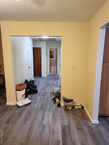 a view of a room with wooden floor and lounge chairs