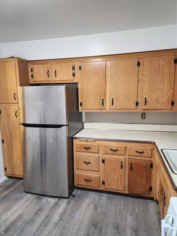 a kitchen with cabinets and a wooden floor
