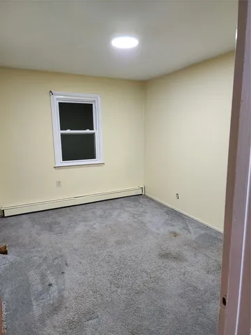 an empty room with a empty space and a window