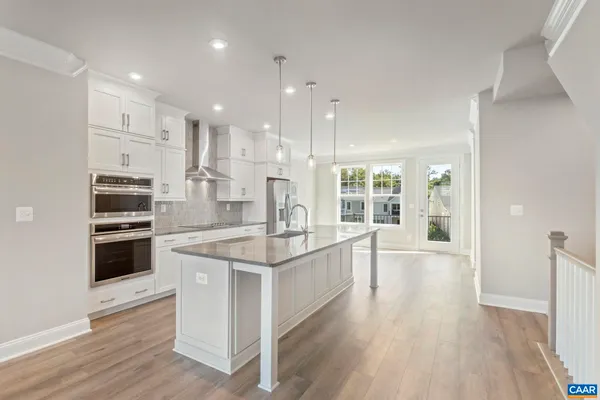 a large kitchen with stainless steel appliances kitchen island granite countertop a large counter top and stove