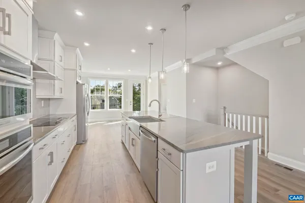 a large kitchen with a sink and a large window