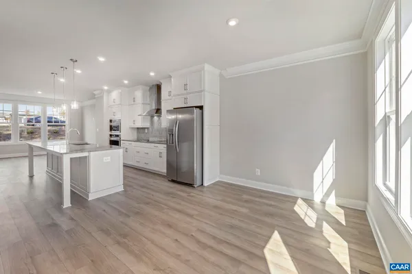 a view of kitchen with wooden floor and electronic appliances