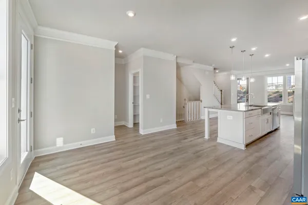 a view of a kitchen with cabinets and wooden floor