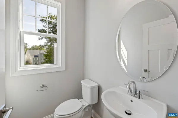 a bathroom with a toilet a sink and a mirror