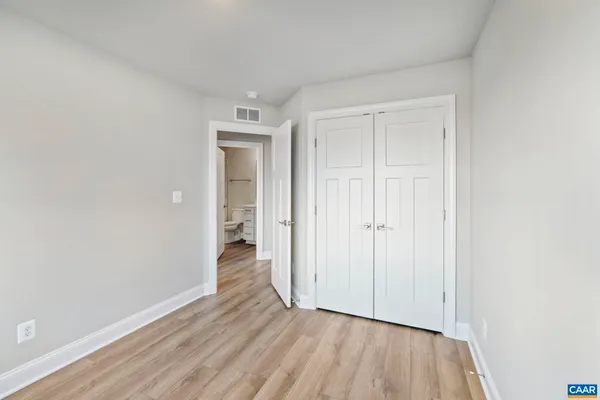 a view of an empty room and wooden floor