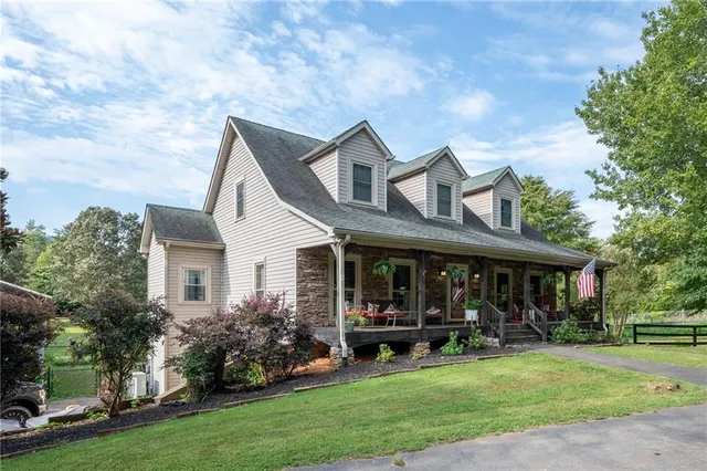 a front view of a house with garden and porch