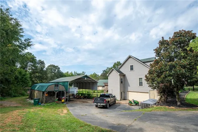 a living room with furniture and a dining table with wooden floor