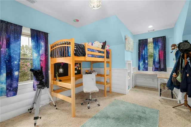 a view of a house with a backyard and trees