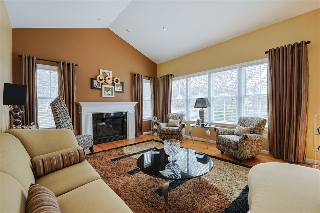 14 Codding Road, Unit 65 Norton, MA 02766 - Photo 14 of 30 a living room with furniture fireplace and a large window