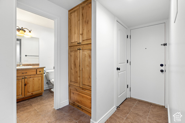 2092 Cres Drive South Mapleton, UT 84664 - Photo 19 of 26 Tile flooring throughout, full-height wood-finish cabinetry, and a white entry door