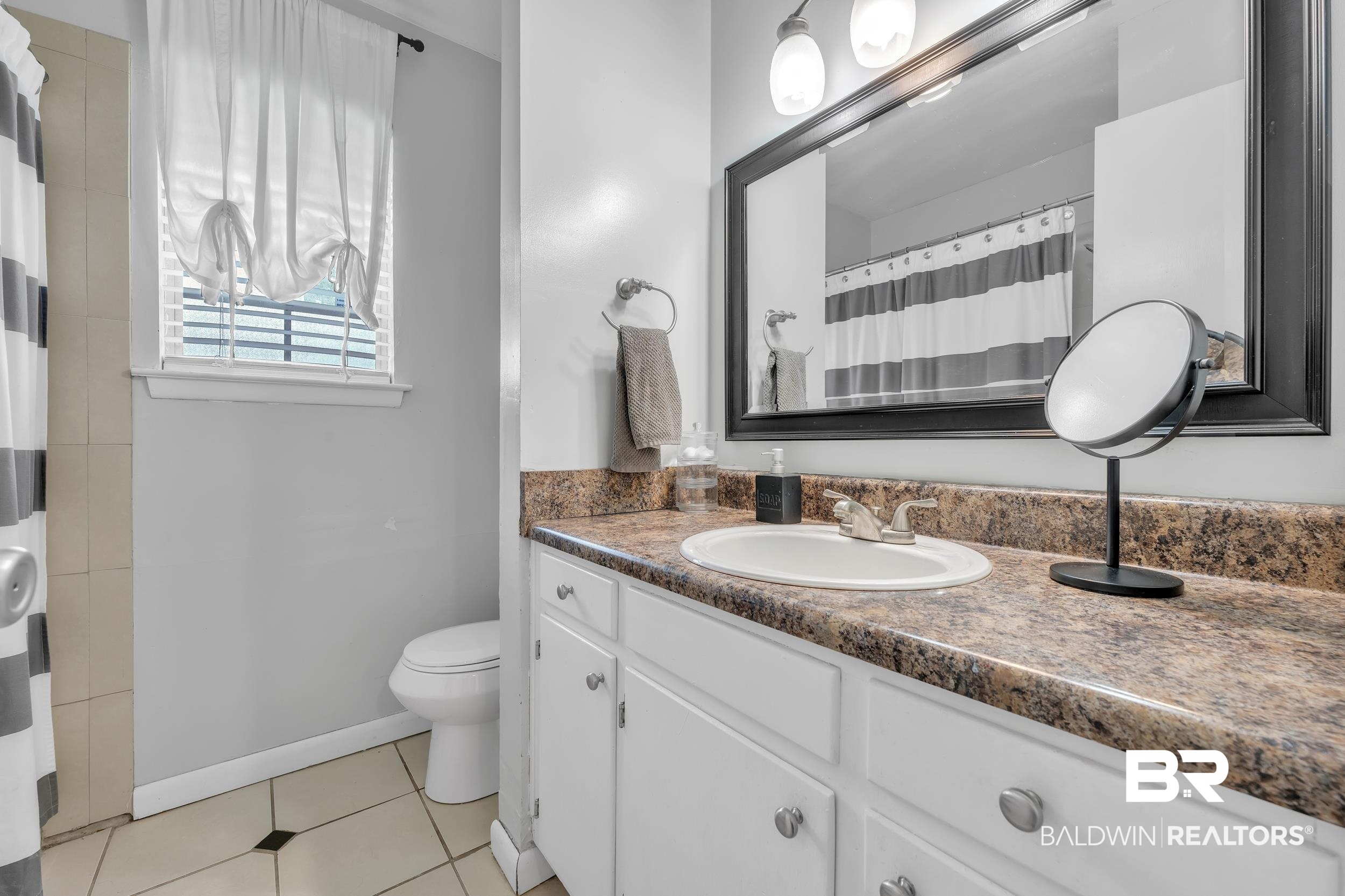224 Cache Circle Mobile, AL 36611 - Photo 23 of 42 Full bath with toilet, vanity, tile patterned floors, baseboards, and curtained shower
