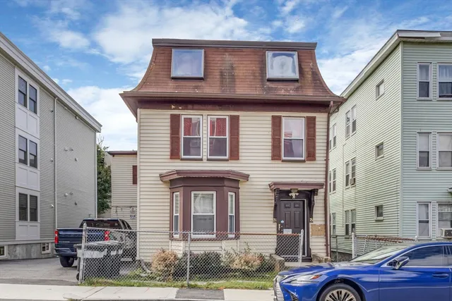 a front view of a house with parking