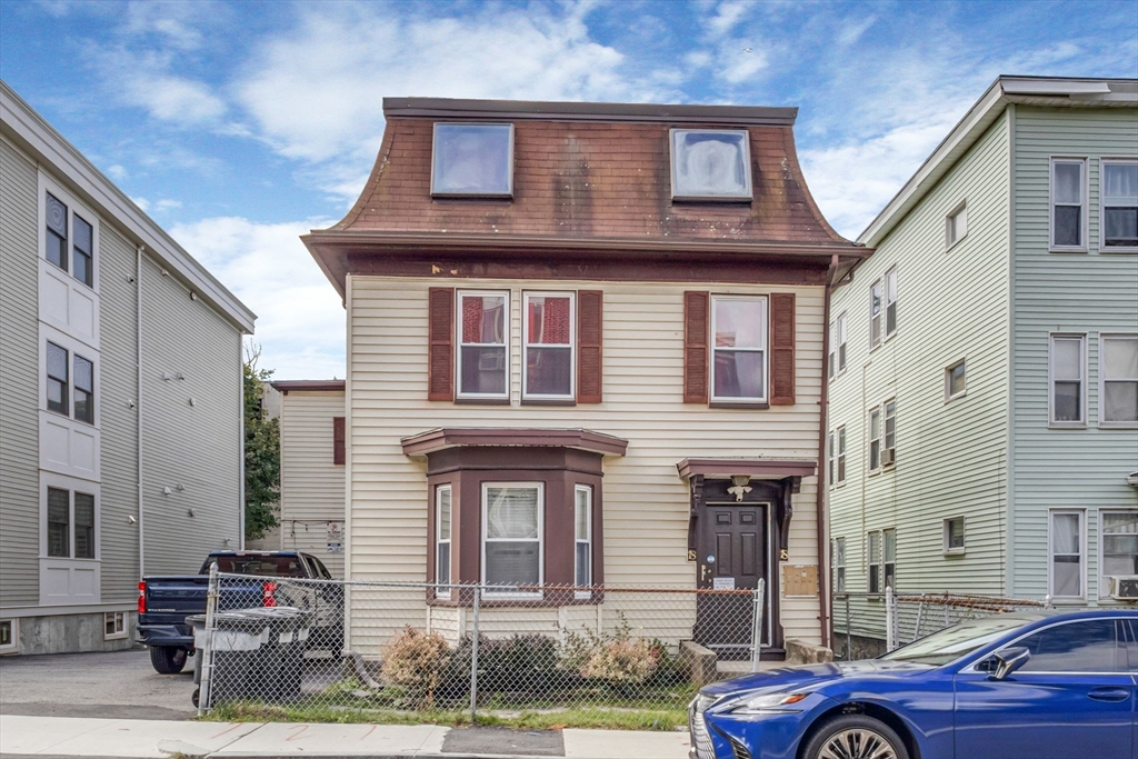 a front view of a house with parking