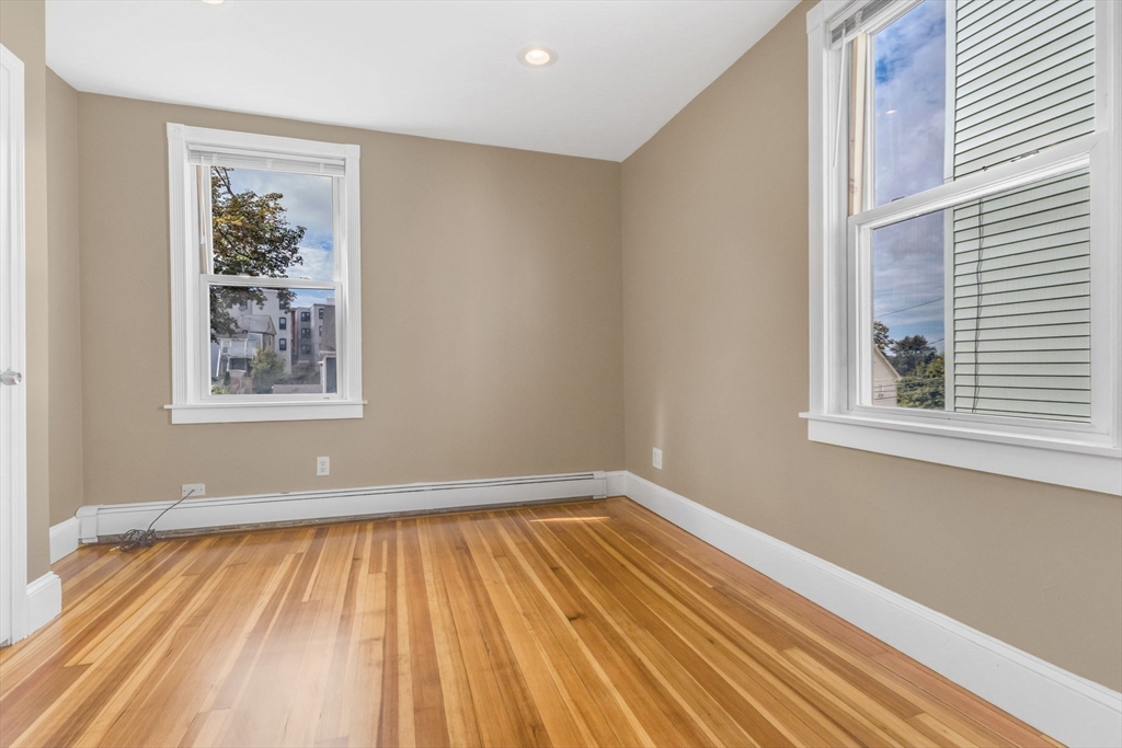 18 School Street, Unit 2 Boston, MA 02119 - Photo 19 of 23 a view of a room with wooden floor and a window