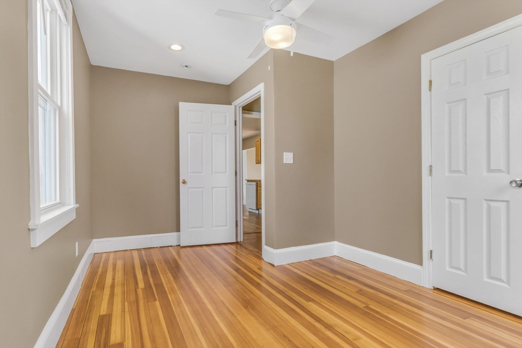 18 School Street, Unit 2 Boston, MA 02119 - Photo 20 of 23 a view of empty room with wooden floor and fan