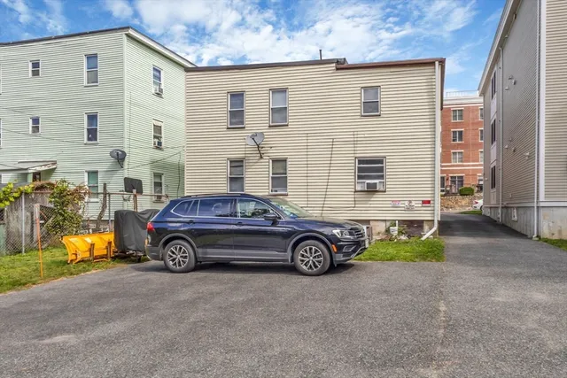 a cars parked in front of a brick house