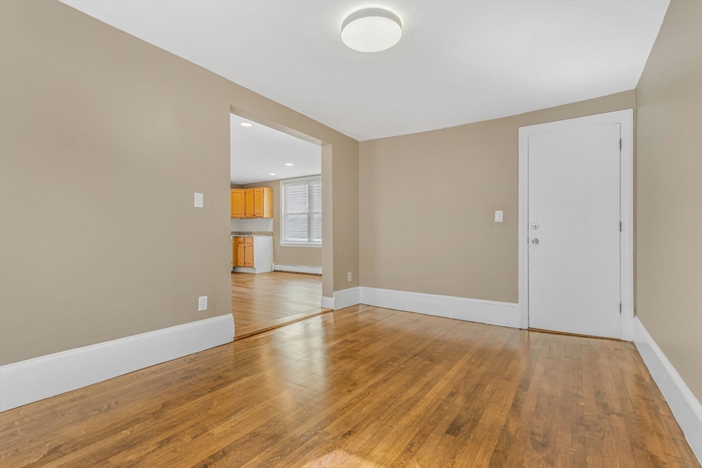 18 School Street, Unit 2 Boston, MA 02119 - Photo 4 of 23 an empty room with wooden floor and windows