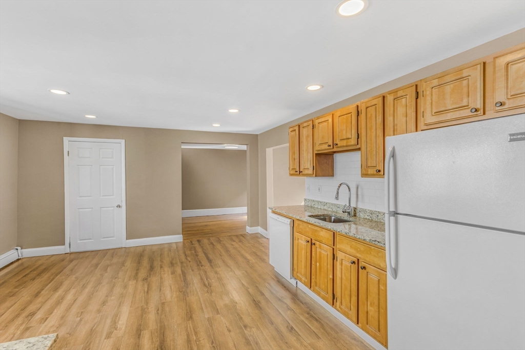 18 School Street, Unit 2 Boston, MA 02119 - Photo 7 of 23 a kitchen with stainless steel appliances granite countertop a sink stove and refrigerator