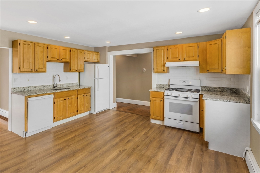 18 School Street, Unit 2 Boston, MA 02119 - Photo 8 of 23 a kitchen with a sink stove and cabinets