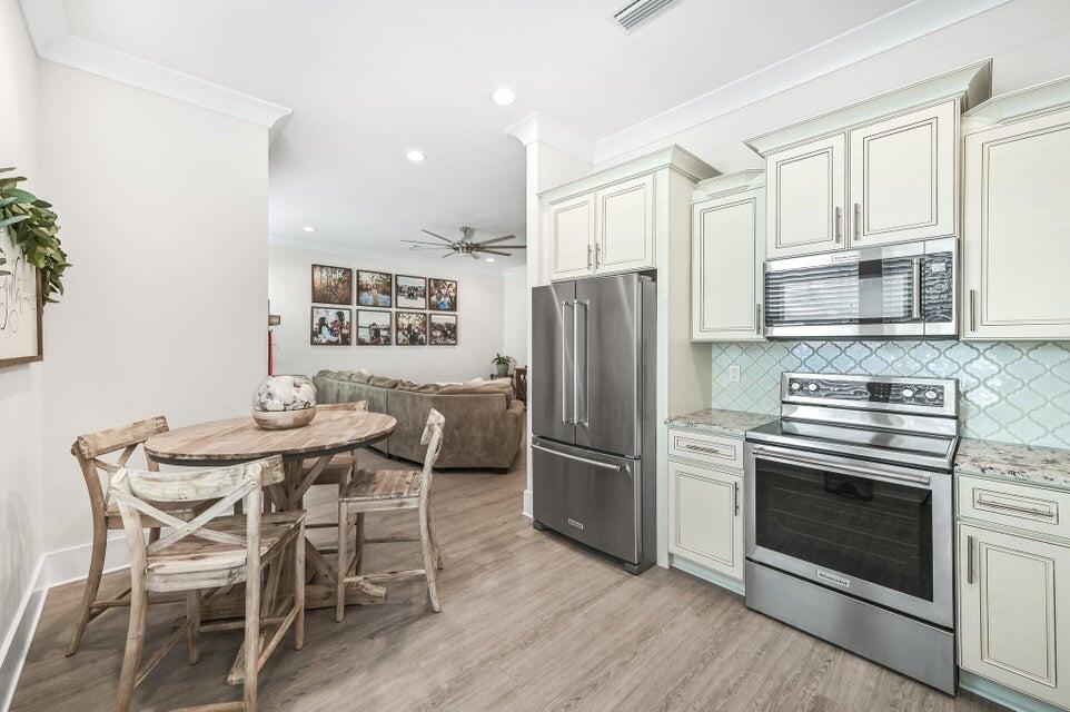 995 Airport Road, Unit 13 Destin, FL 32541 - Photo 11 of 32 a kitchen with stainless steel appliances a refrigerator stove microwave and cabinets