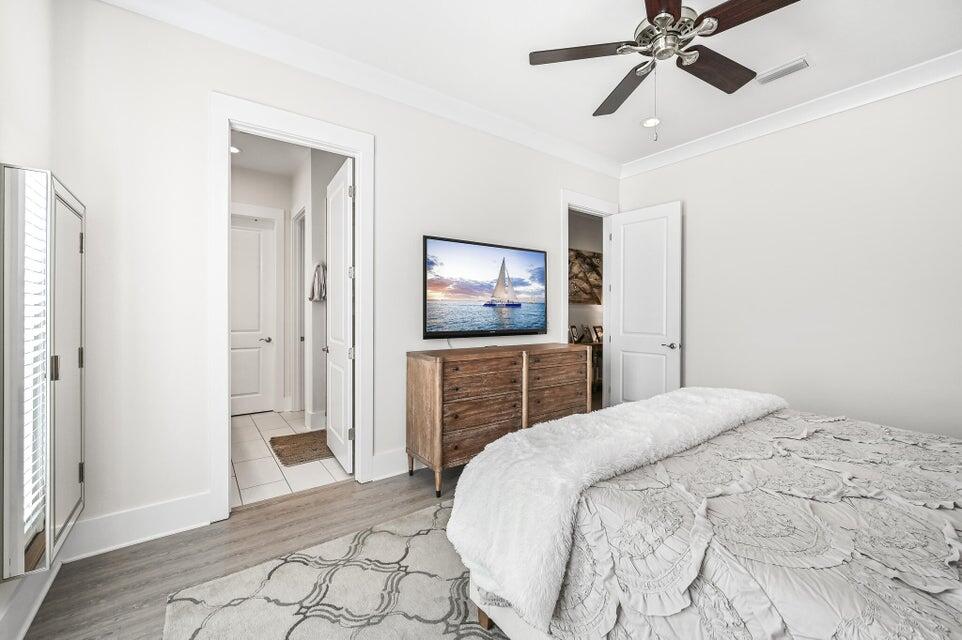 995 Airport Road, Unit 13 Destin, FL 32541 - Photo 14 of 32 a bedroom with a bed and a flat screen tv