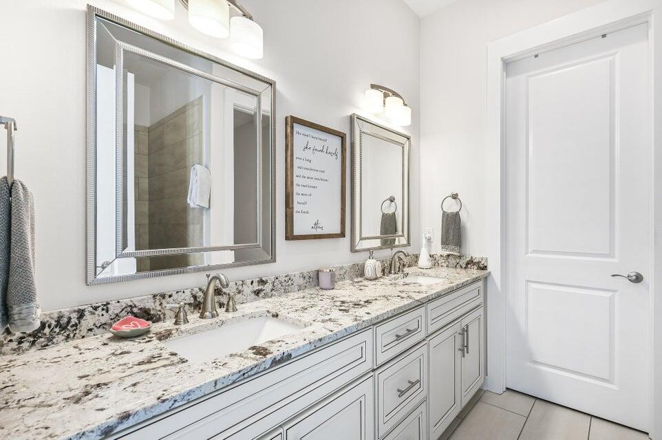 995 Airport Road, Unit 13 Destin, FL 32541 - Photo 15 of 32 a bathroom with a granite countertop sink and a mirror