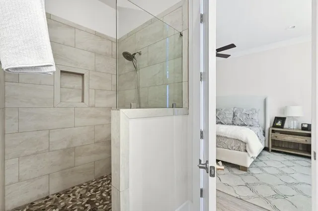 a bathroom with a granite countertop sink toilet and shower