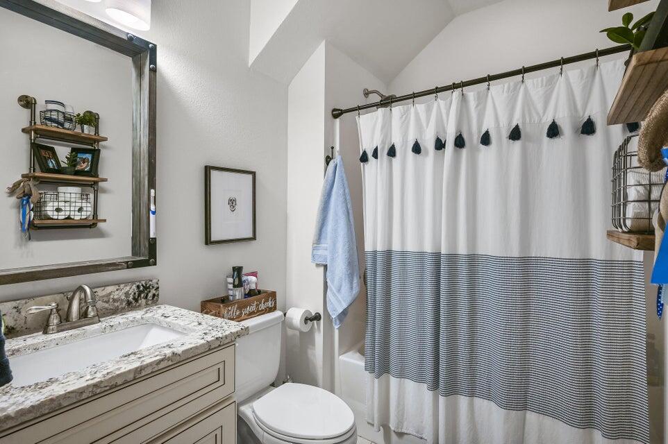 995 Airport Road, Unit 13 Destin, FL 32541 - Photo 17 of 32 a bathroom with a granite countertop sink toilet and shower