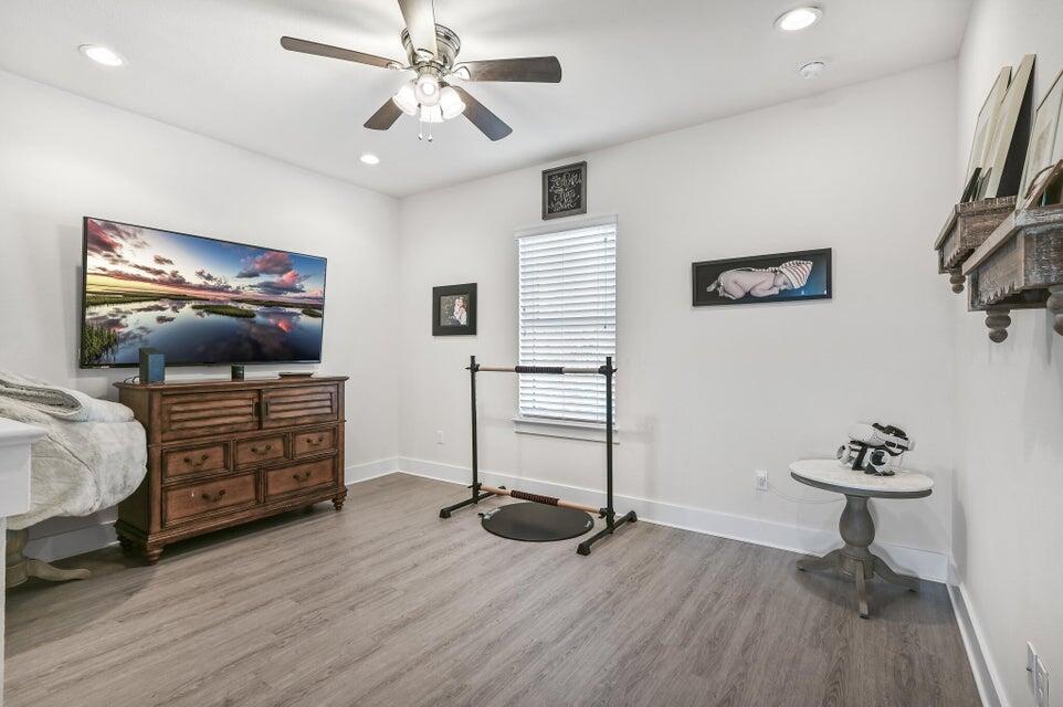 995 Airport Road, Unit 13 Destin, FL 32541 - Photo 18 of 32 a room with furniture and wooden floor