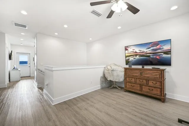 a view of a livingroom with furniture and a flat screen tv