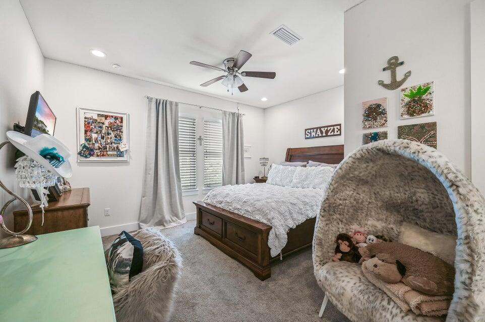 995 Airport Road, Unit 13 Destin, FL 32541 - Photo 25 of 32 a spacious bedroom with a bed and ceiling fan