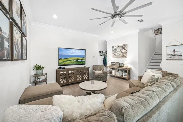 a living room with furniture and wooden floor