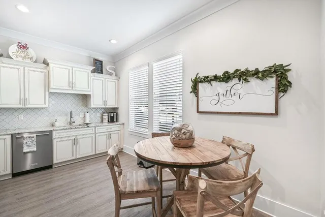 a kitchen with a refrigerator sink and cabinets