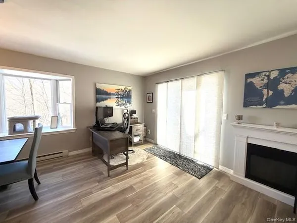 a living room with furniture a fireplace and a flat screen tv