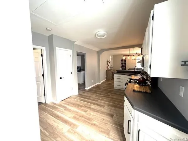a kitchen with stainless steel appliances granite countertop a stove top oven a sink a counter space and cabinets