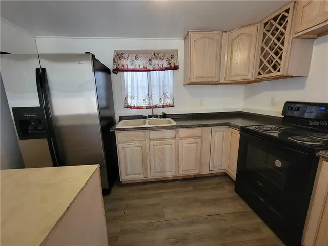 a kitchen with white cabinets sink and stainless steel appliances