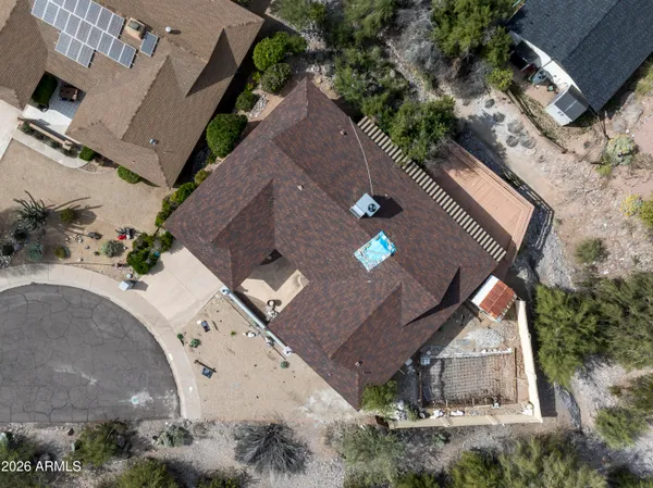 an aerial view of a house with a yard