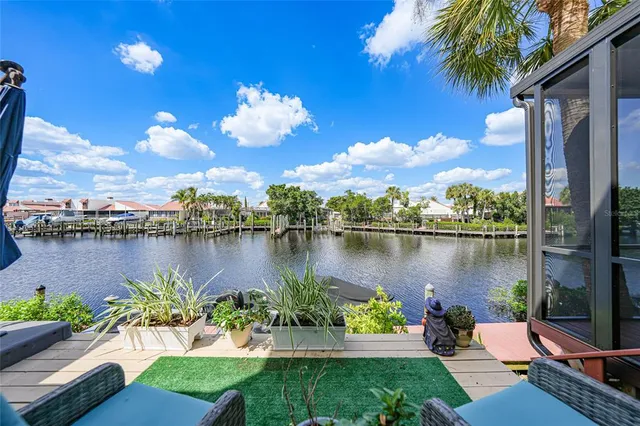 a view of a lake with a table potted plants and lake view