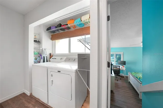 a view of hallway with wooden floor and furniture