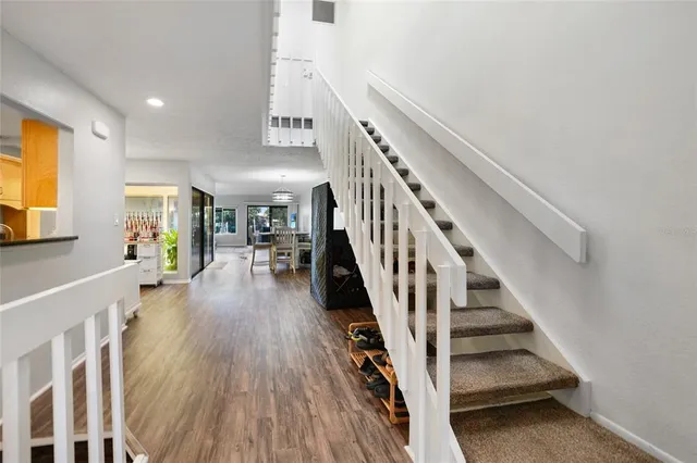 a view of entryway and hall with wooden floor
