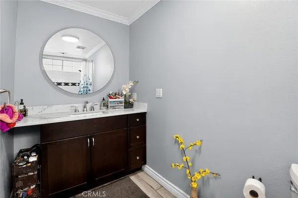 a bathroom with a sink mirror and vanity