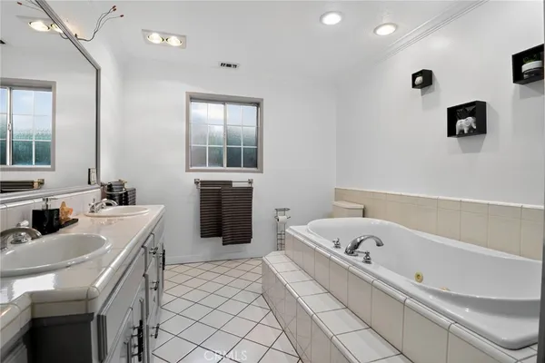 a bathroom with a tub sink and mirror