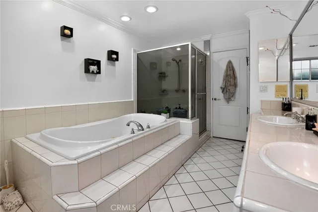 a bathroom with a tub a sink and a mirror