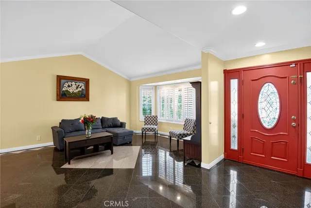 a living room with furniture a table and a potted plant