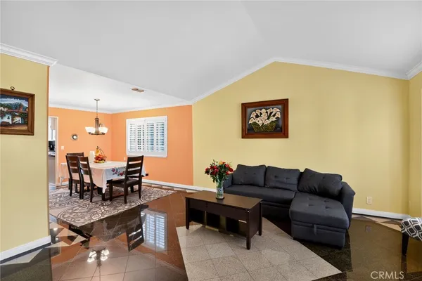 a living room with furniture wooden floor and a window