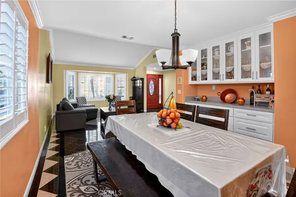 a living room with furniture pool table and large windows