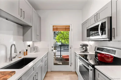 a kitchen that has a sink and a stove