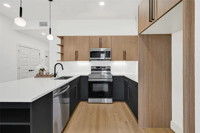 a kitchen with a sink stove and microwave