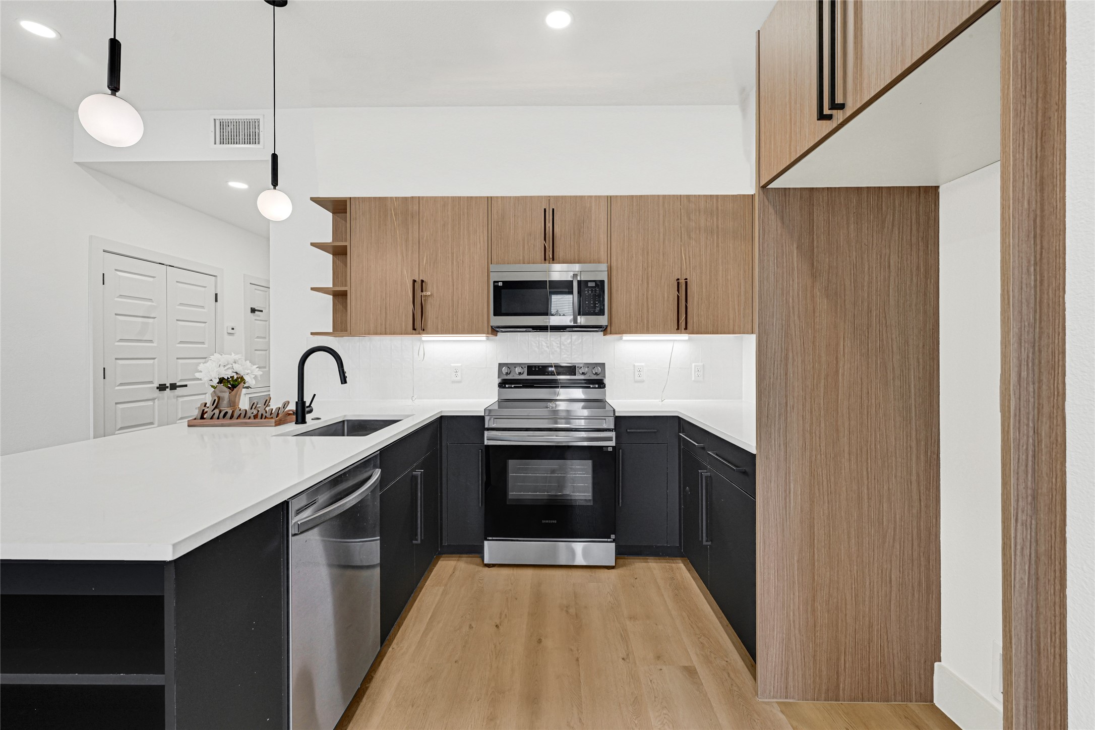327 Tite Street, Unit B Houston, TX 77029 - Photo 11 of 22 a kitchen with sink a stove and refrigerator
