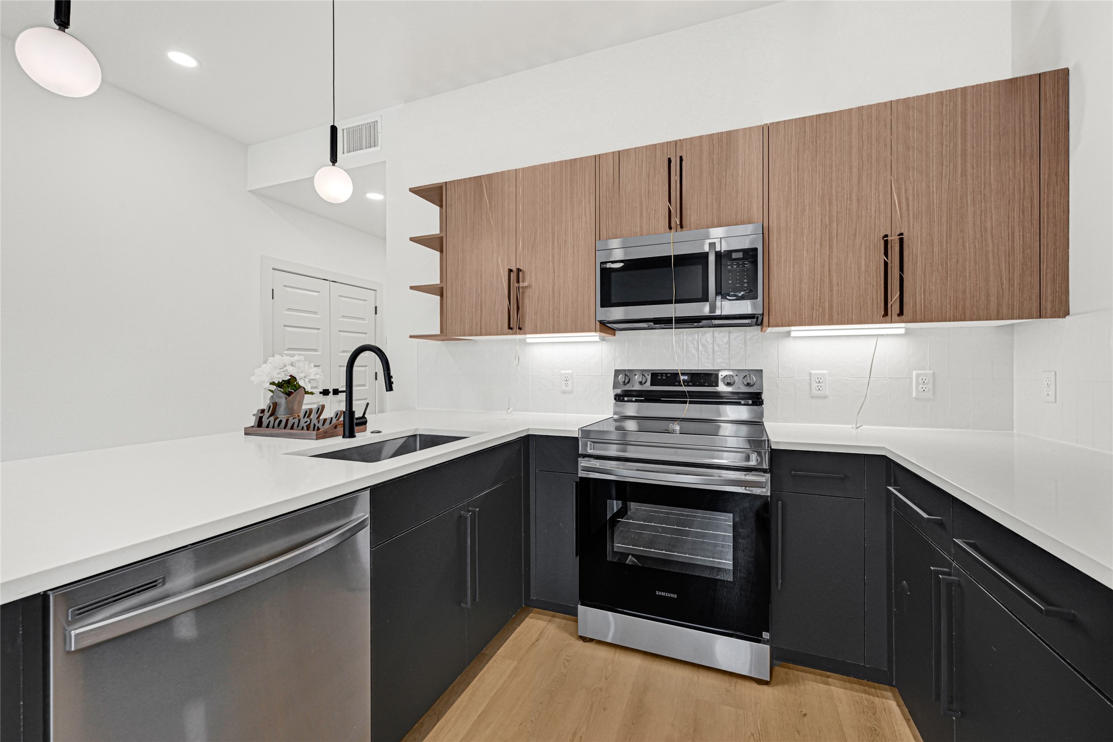 327 Tite Street, Unit B Houston, TX 77029 - Photo 12 of 22 a kitchen with a sink stove and microwave